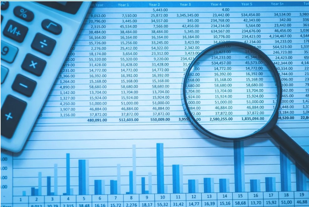 spreadsheet with data, graph, magnifying glass, and calculator