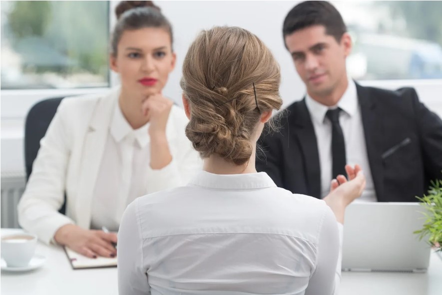 woman interviewing with 2 business people