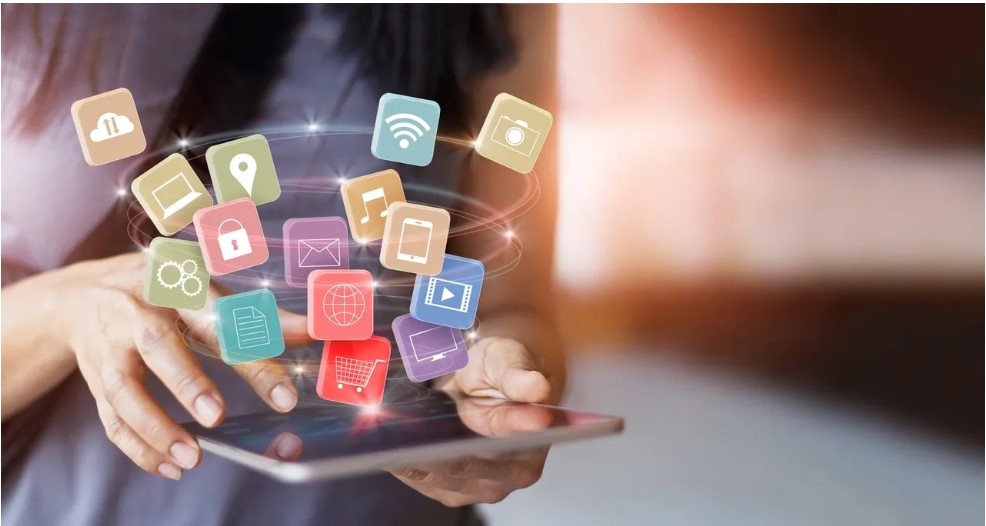 woman holding tablet with social media and other apps in view